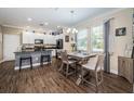 Open kitchen with white cabinets, granite countertops, and a dining area at 10595 Marsha Dr, New Port Richey, FL 34655