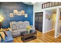 Living room with gray couch, coffee table, and wood-look flooring at 1775 Cupecoy Cir # O4, Lutz, FL 33558