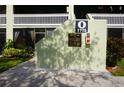 Entrance to a building with a smoke-free community sign and landscaping at 1775 Cupecoy Cir # O4, Lutz, FL 33558