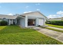 Light blue home exterior with an open garage at 8833 Manos Cir # 8833, New Port Richey, FL 34655