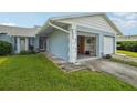 Light blue home exterior with an open garage at 8833 Manos Cir # 8833, New Port Richey, FL 34655