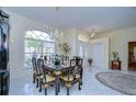 Bright dining room featuring a formal table setting and large window at 8704 Cypress Lakes Blvd, New Port Richey, FL 34653