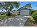 Single story home with attached garage and mature landscaping at 6387 Plantation Rd, Spring Hill, FL 34606