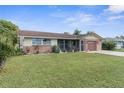 Brick ranch home with attached garage and spacious lawn at 10316 Amadeus Dr, Port Richey, FL 34668