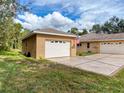 Detached garage with white door and stucco exterior at 11281 Godwit Ave, Weeki Wachee, FL 34613