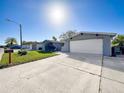 Single-Gathering home with driveway and attached garage at 7310 Rockwood Dr, Port Richey, FL 34668