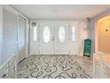 Bright and spacious entryway with double doors and decorative rug at 7310 Rockwood Dr, Port Richey, FL 34668