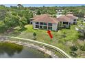 Lakeside condo with a screened lanai and manicured lawn at 7719 Cosme Dr # 1, Hudson, FL 34667