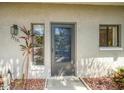 Condo unit entrance with a screen door and window at 7719 Cosme Dr # 1, Hudson, FL 34667