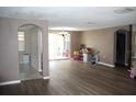 Living room with laminate floors and access to patio at 7204 Westcott Dr, Port Richey, FL 34668