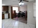 Open dining area and kitchen with laminate flooring at 7204 Westcott Dr, Port Richey, FL 34668