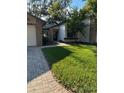 Inviting exterior of a single-story home with a well-maintained lawn and paved walkway at 7486 Heather Walk Dr # 31, Weeki Wachee, FL 34613