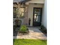 Front entrance with a paved walkway leading to the home's entry door at 7486 Heather Walk Dr # 31, Weeki Wachee, FL 34613
