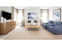 Spacious living room with a neutral color palette and ample natural light at 10421 High Noon Trl, Parrish, FL 34219