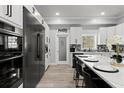 Modern kitchen with stainless steel appliances, a pantry, and a spacious island with bar seating at 14485 Switch Back Rd, Brooksville, FL 34609