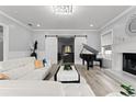 Elegant living room featuring a grand piano, fireplace, and sliding barn doors at 14485 Switch Back Rd, Brooksville, FL 34609