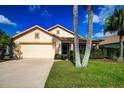 Single-story house with a two-car garage and landscaped yard at 20743 Nectarine Pl, Land O Lakes, FL 34637