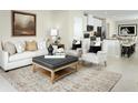 Spacious living room featuring a comfortable sofa and stylish armchairs at 4636 Spire Run, Lakewood Ranch, FL 34211