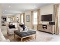 Open living room with a modern media console and comfortable seating at 4636 Spire Run, Lakewood Ranch, FL 34211