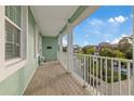 Covered balcony with white railings overlooking a residential neighborhood at 5632 Egrets Pl, New Port Richey, FL 34652