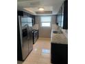 Updated kitchen with dark cabinets and granite counters at 6417 Sutherland Ave, New Port Richey, FL 34653
