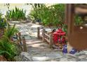 Lush backyard walkway and bridge with plants offering a serene outdoor experience at 8231 Coral Creek Loop, Hudson, FL 34667