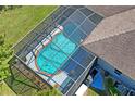 Enclosed rectangular pool with a screened enclosure at 11909 Wexford Blvd, Spring Hill, FL 34609