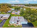 Aerial view of a single-story home with a light blue exterior and a two-car garage at 12031 Boynton Ln # B, New Port Richey, FL 34654