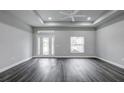 Spacious living room with dark gray vinyl plank flooring and high ceilings at 12260 Quigley Ave, Weeki Wachee, FL 34614