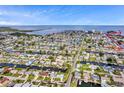 Waterfront property shown in an aerial view, showcasing the neighborhood and canal access at 13809 Gene Rossi Ave, Hudson, FL 34667