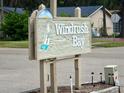 Community entrance sign for Windrush Bay with sailboat graphic at 427 Windrush Bay Dr # 427, Tarpon Springs, FL 34689