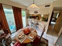 Bright dining area with a round table, access to a patio, and kitchen views at 427 Windrush Bay Dr # 427, Tarpon Springs, FL 34689