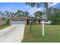 Brick ranch house with a two-car garage at 6489 Pine Meadows Dr, Spring Hill, FL 34606