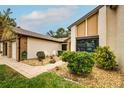 Brick walkway leads to front door, surrounded by landscaping at 7499 Heather Walk, Weeki Wachee, FL 34613