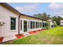 Private backyard with a spacious sunroom and well-maintained lawn at 7499 Heather Walk, Weeki Wachee, FL 34613