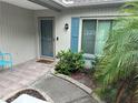 Inviting front entry with teal door and landscaped walkway at 8353 Forest Oaks Blvd, Spring Hill, FL 34606