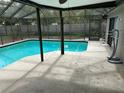 Large screened pool area with patio and covered seating at 8353 Forest Oaks Blvd, Spring Hill, FL 34606