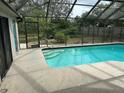 Relaxing screened pool with tiled steps and spacious deck at 8353 Forest Oaks Blvd, Spring Hill, FL 34606