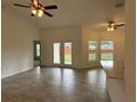 Bright and spacious living area with tile floors and access to the backyard at 10115 Briar Cir, Hudson, FL 34667