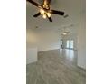 Open living room featuring tile floors and ceiling fans at 10115 Briar Cir, Hudson, FL 34667