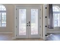 Elegant double doors with decorative glass inserts, leading to the home's interior at 10441 Garda Dr, Trinity, FL 34655
