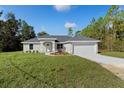 One-story home with attached garage and front yard at 14328 Chimney Swift Rd, Weeki Wachee, FL 34614