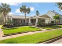 Charming single story home with a beautifully landscaped lawn at 203 S Spring Blvd, Tarpon Springs, FL 34689