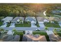 Aerial view of a residential street with houses, solar panels, and lush greenery at 2533 Wood Pointe Dr, Holiday, FL 34691