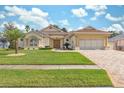 Stunning one-story house with a lush green lawn and driveway at 3527 Conifer Loop, Spring Hill, FL 34609