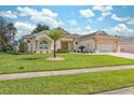 House exterior with palm trees and a well-kept lawn at 3527 Conifer Loop, Spring Hill, FL 34609