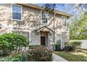 Inviting two-story townhome exterior with landscaping and walkway at 7650 Red Mill Cir, New Port Richey, FL 34653