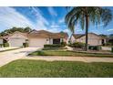 Two-unit home with attached garages and manicured landscaping at 6244 Fairskies Dr, New Port Richey, FL 34655