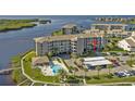 Aerial view of condo building with pool and parking at 8141 Aquila St # 347, Port Richey, FL 34668