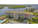 Aerial view of a waterfront condo building with a pool and boat slips at 8141 Aquila St # 347, Port Richey, FL 34668